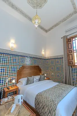 a bedroom with a large bed in a room at Riad Al Mozyane in Fès