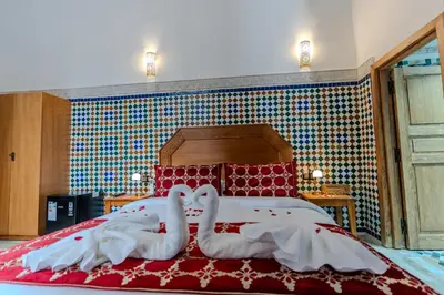 a bed with two swans made out of towels at Riad Al Mozyane in Fès