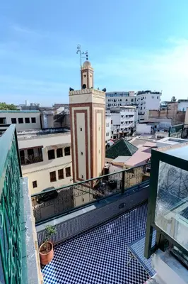 a building with a clock tower on top of a city at Riad Al Mozyane in Fès