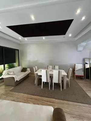 a living room with a table and a couch at villa imouzzer in Imouzzer Kandar
