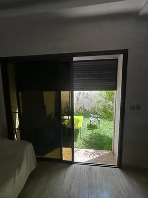 a bedroom with a sliding glass door to a patio at villa imouzzer in Imouzzer Kandar