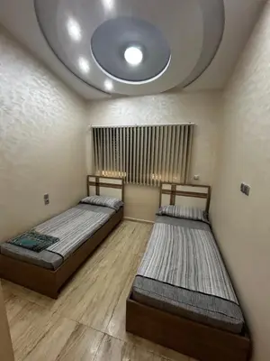 two beds in a room with a ceiling at villa imouzzer in Imouzzer Kandar