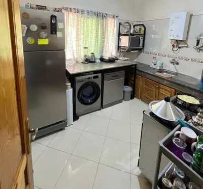 a kitchen with a refrigerator and a dishwasher at Appartement cosy à Fès in Fès