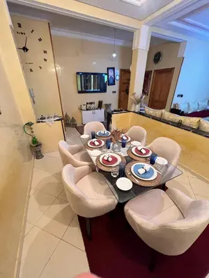 a dining room with a table and some chairs at Appartement cosy à Fès in Fès