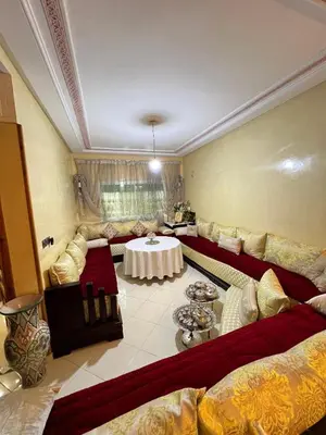 a large living room with couches and a table at Appartement cosy à Fès in Fès