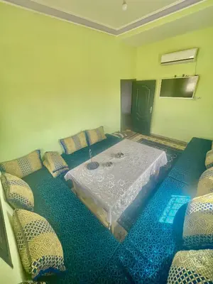 a room with a table and some pillows at Tinzouline in Tinzouline