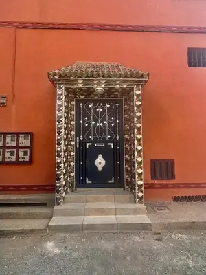 a black door in front of a building at Tinzouline in Tinzouline