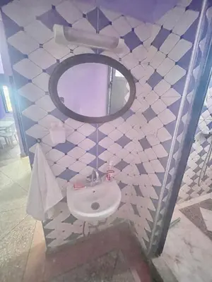a bathroom with a sink and a mirror at Tinzouline in Tinzouline