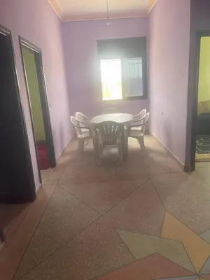 a dining room with a table and chairs and a window at Tinzouline in Tinzouline