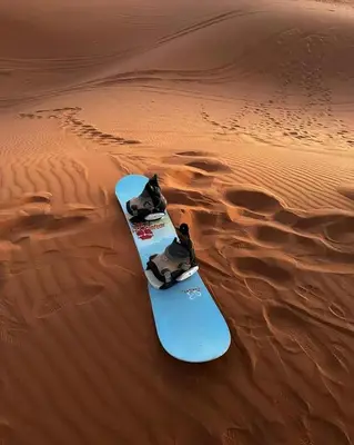 a snowboard in the sand in the desert at Shahrazad Nights Desert Camp in Merzouga