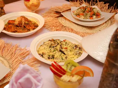 a table with several plates of food on it at Shahrazad Nights Desert Camp in Merzouga