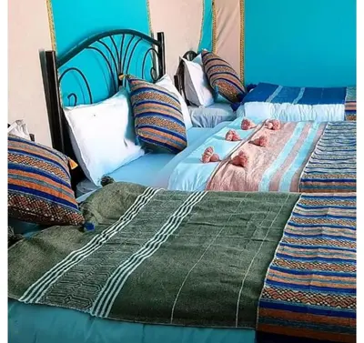 two twin beds sitting next to each other at Staying Desert Luxury Camp in Merzouga