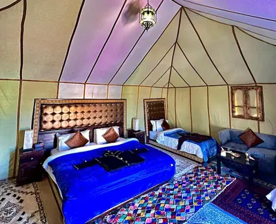 a room with two beds in a tent at Staying Desert Luxury Camp in Merzouga