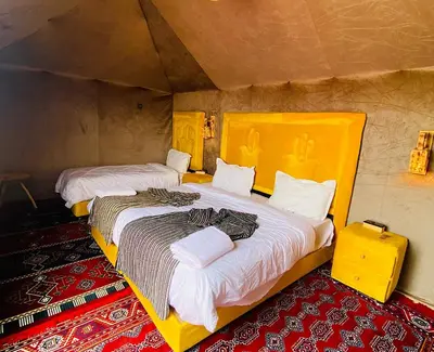 a bedroom with two beds in a room at Staying Desert Luxury Camp in Merzouga
