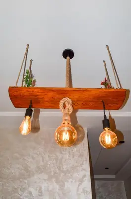 a group of lights hanging from a wooden beam at Appartement Nadine Fès in Fès