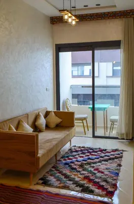 a living room with a couch and a table at Appartement Nadine Fès in Fès