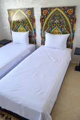 two beds sitting next to each other in a room at Appartement Nadine Fès in Fès