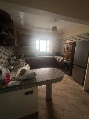 a kitchen with a counter and a refrigerator at Appartement à louer 67 m à Safi in Oulad Akkou