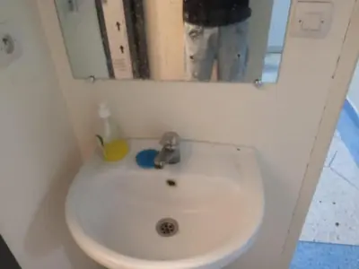 a white sink in a bathroom with a mirror at House of Dreams in Khenifra