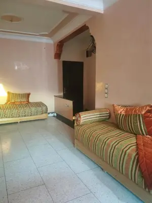 a living room with two couches in a room at Appart à merjane in Meknès