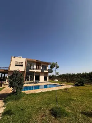 a house with a swimming pool in a yard at Villa avec piscine in Meknès