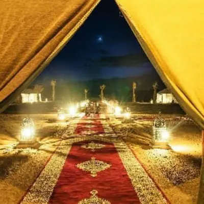 a view of a room with a red carpet and lights at Tenere luxury camp in Merzouga