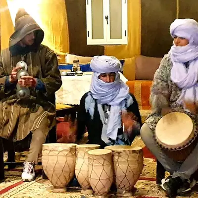 a group of three people sitting in a room with vases at Tenere luxury camp in Merzouga
