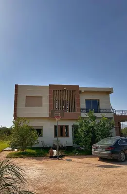 a house with a car parked in front of it at Villa avec piscine in Meknès