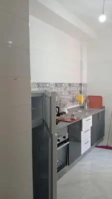 a kitchen with a stainless steel refrigerator and counters at La maison verte in Fès