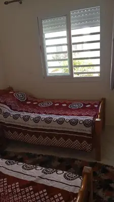 a bed sitting in a room with a window at La maison verte in Fès