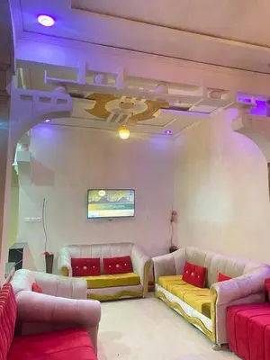 a living room with two couches and a tv at Location de vacance in Azrou