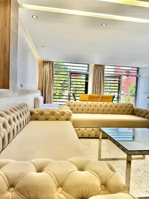 a living room with two couches and a table at dar diyafa in Beni Mellal