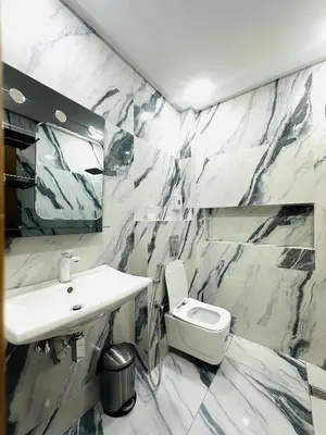 a bathroom with a white sink and a toilet at dar diyafa in Beni Mellal