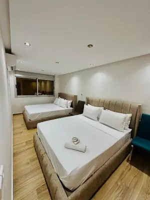 a hotel room with two beds and a couch at dar diyafa in Beni Mellal