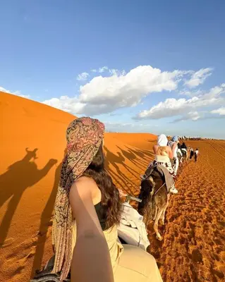 a group of people riding horses in the desert at Merzouga Solace Luxury Camp in Merzouga