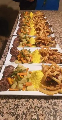 a row of plates of food on a table at Merzouga Solace Luxury Camp in Merzouga