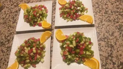three plates of fruit with vegetables and orange slices at Merzouga Solace Luxury Camp in Merzouga
