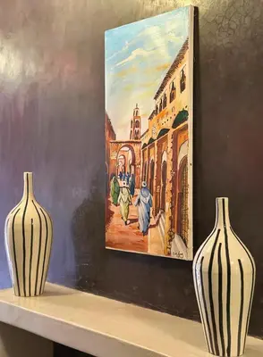 two vases sitting on a shelf next to a painting at Villa Chocolat Deluxe in Marrakech