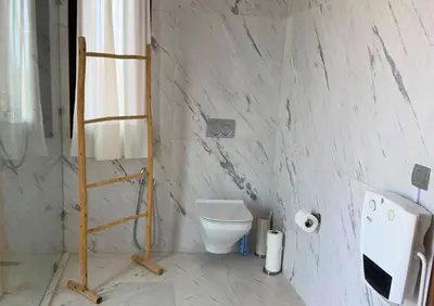 a bathroom with a toilet and a ladder in it at Villa Chocolat Deluxe in Marrakech