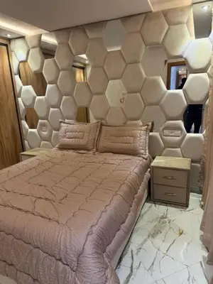 a bedroom with a large bed and a large wall at Un bel appartement in Oulad Akkou