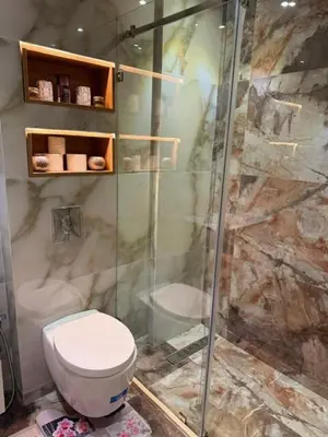 a bathroom with a toilet and a shower at Un bel appartement in Oulad Akkou