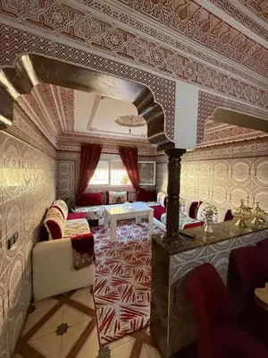 a living room with a couch and a table at Maison vacancier in Oulad Akkou