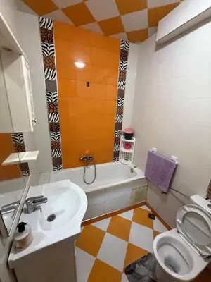 a bathroom with a sink and a tub and a toilet at Maison vacancier in Oulad Akkou