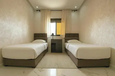 a bedroom with two beds and a window at Appartement 2 chambres 1 salon in Azrou