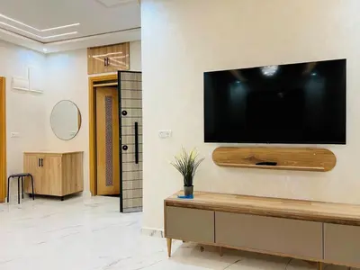 a large flat screen tv hanging on a wall at Appartement 2 chambres 1 salon in Azrou