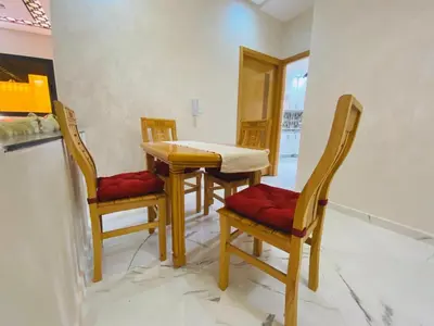 a dining room with a table and four chairs at Appartement 2 chambres 1 salon in Azrou