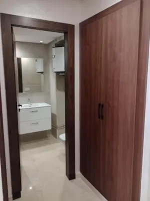 a bathroom with a toilet and a wooden door at Résidence les princesses champs de course in Fès