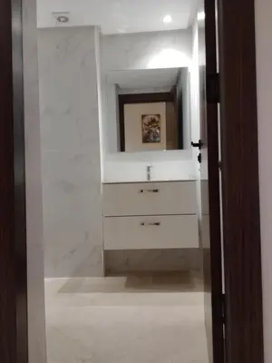 a bathroom with a sink and a mirror at Résidence les princesses champs de course in Fès
