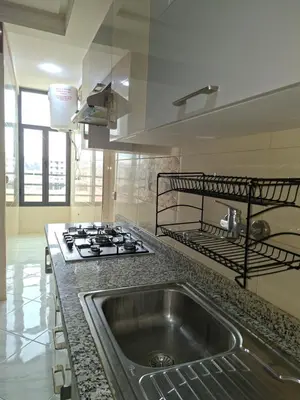 a kitchen with a sink and a stove at Résidence Al Qaraouiyine in Fès