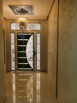 a room with a door with a window and a chandelier at Résidence Al Qaraouiyine in Fès